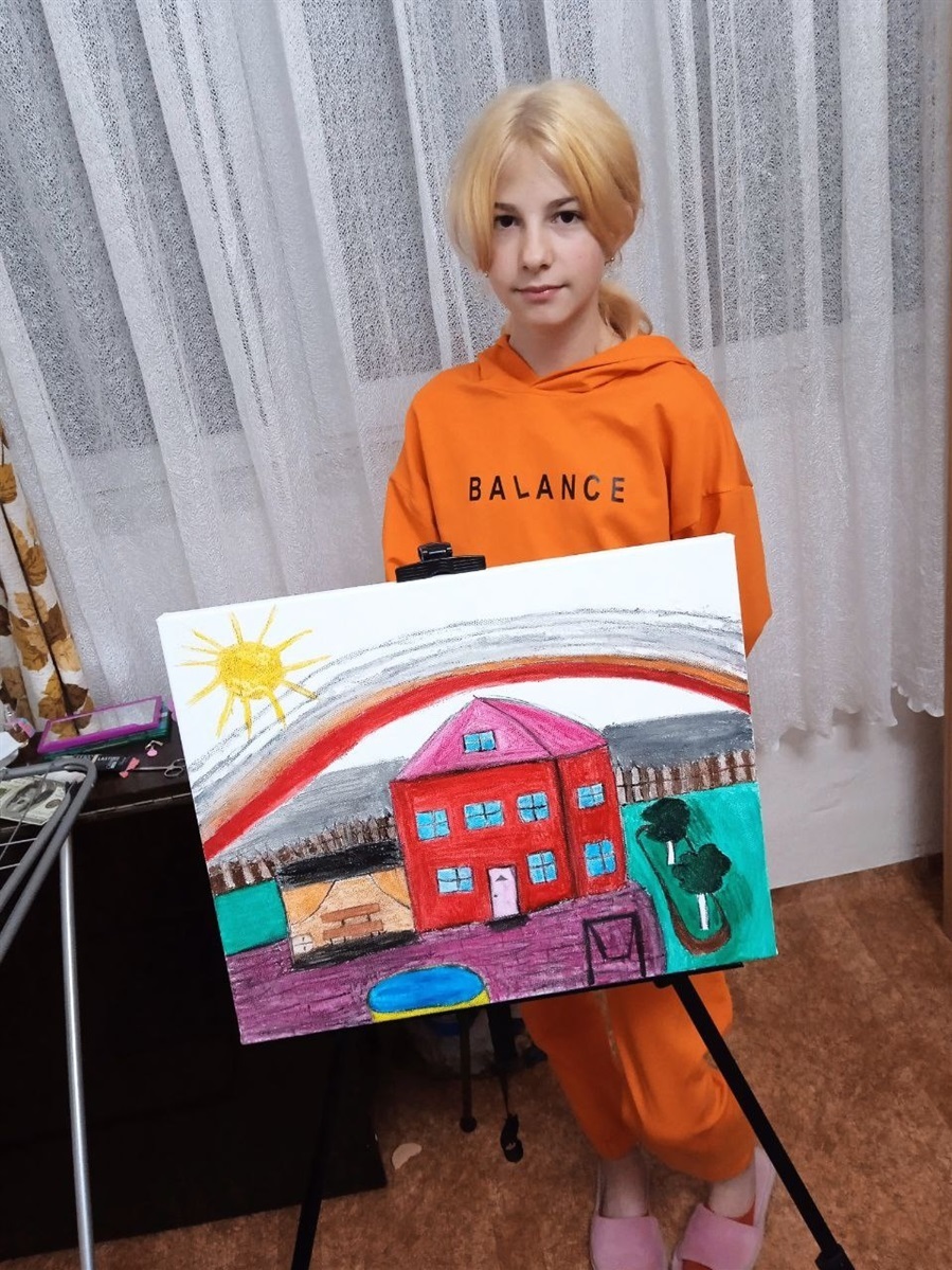 A girl holding her painting
