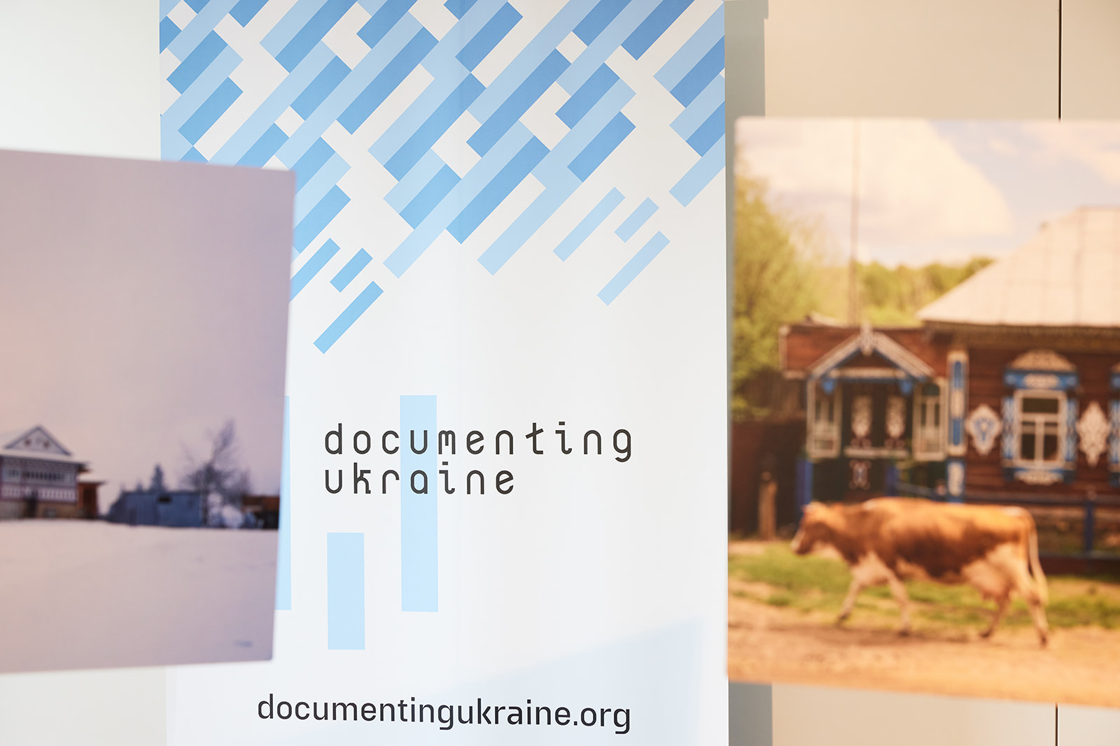 Roll up with Documenting Ukraine project logo and two pictures