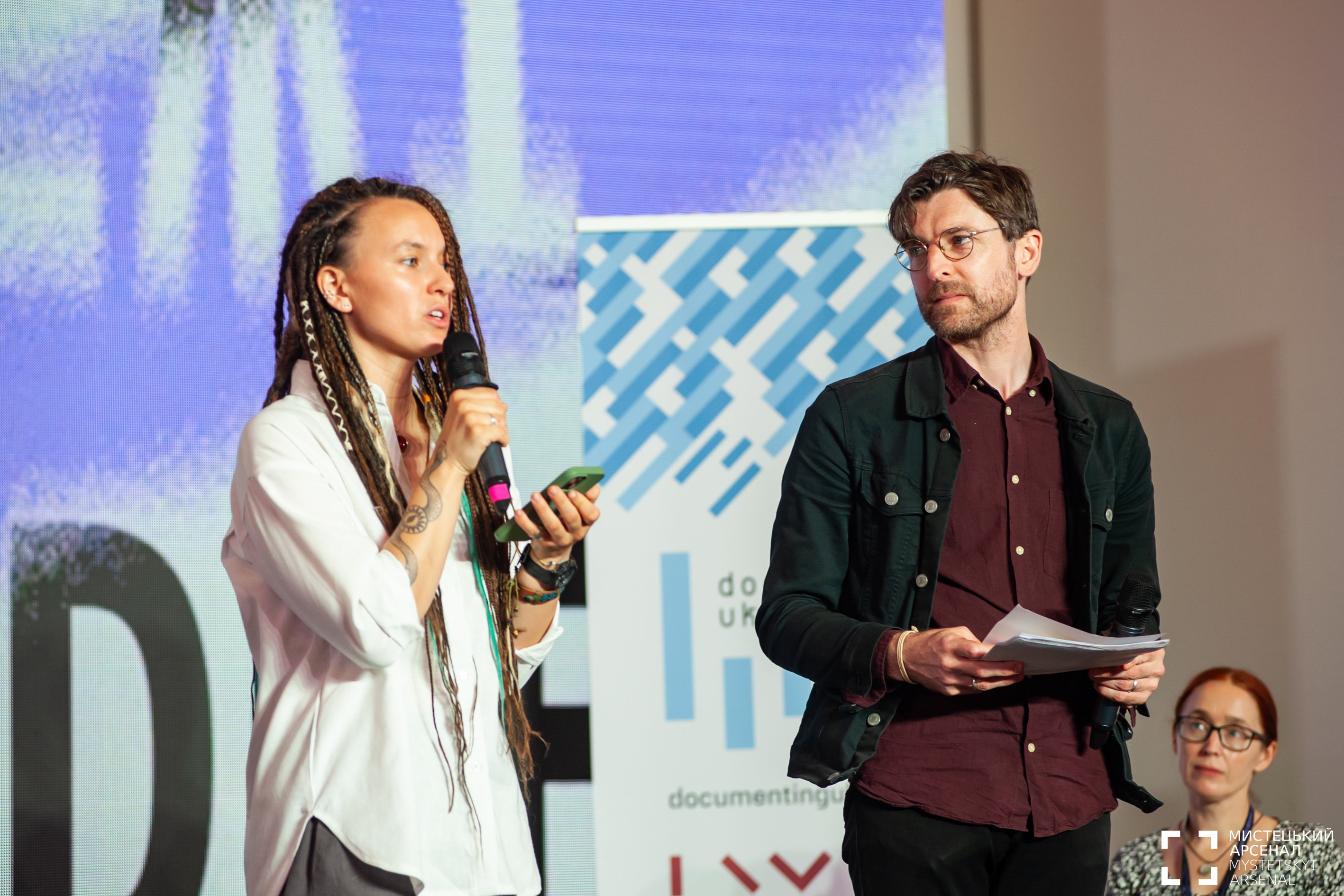 "Two poets performing on stage"