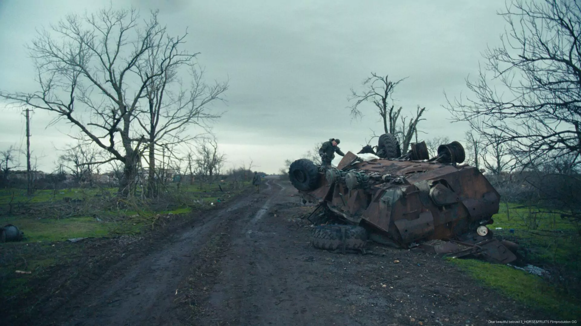 A wrecked military vehicle on the road