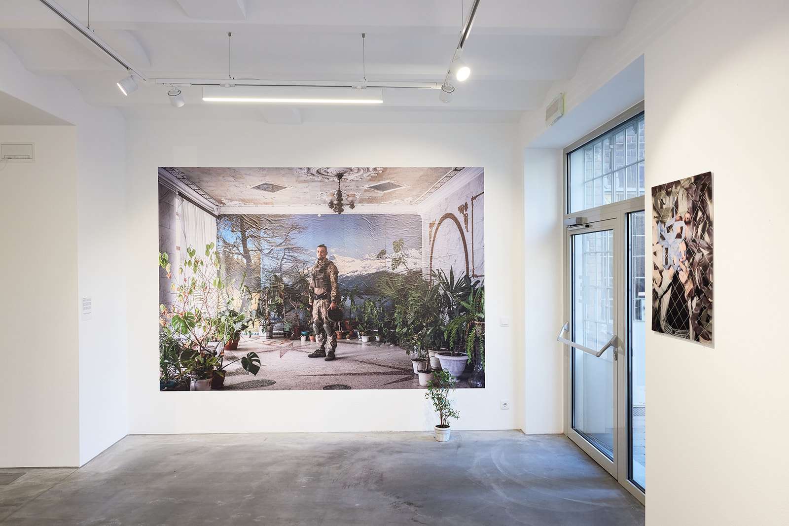 Portrait of the Ukrainian soldier surrounded by the indoor plants on the wall