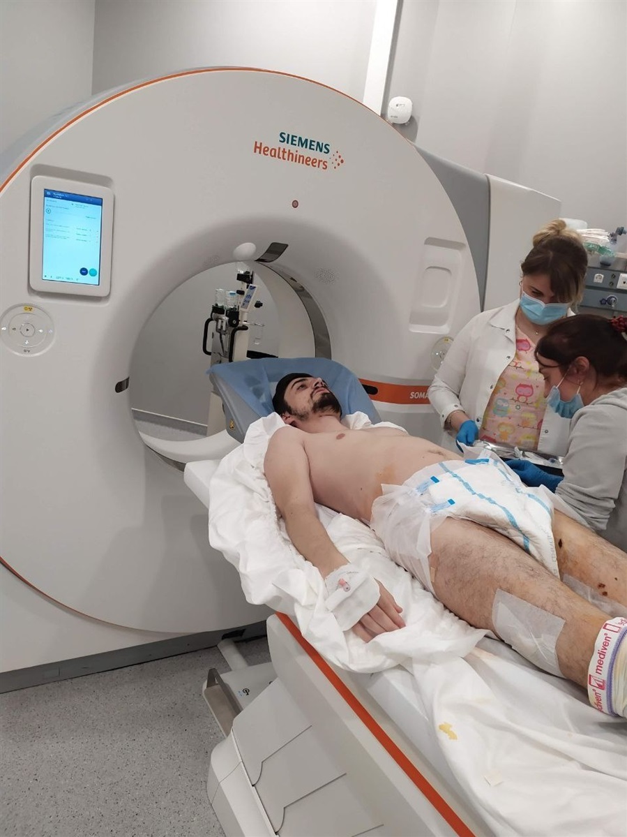 A man in a hospital with doctors preparing for an examination