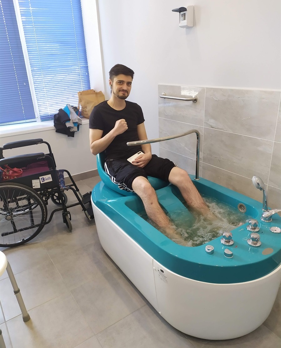 A man during water procedures as part of rehabilitation