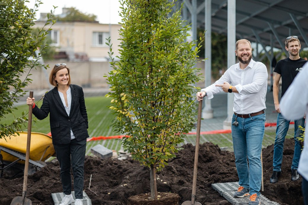 A woman and a man plant a tree