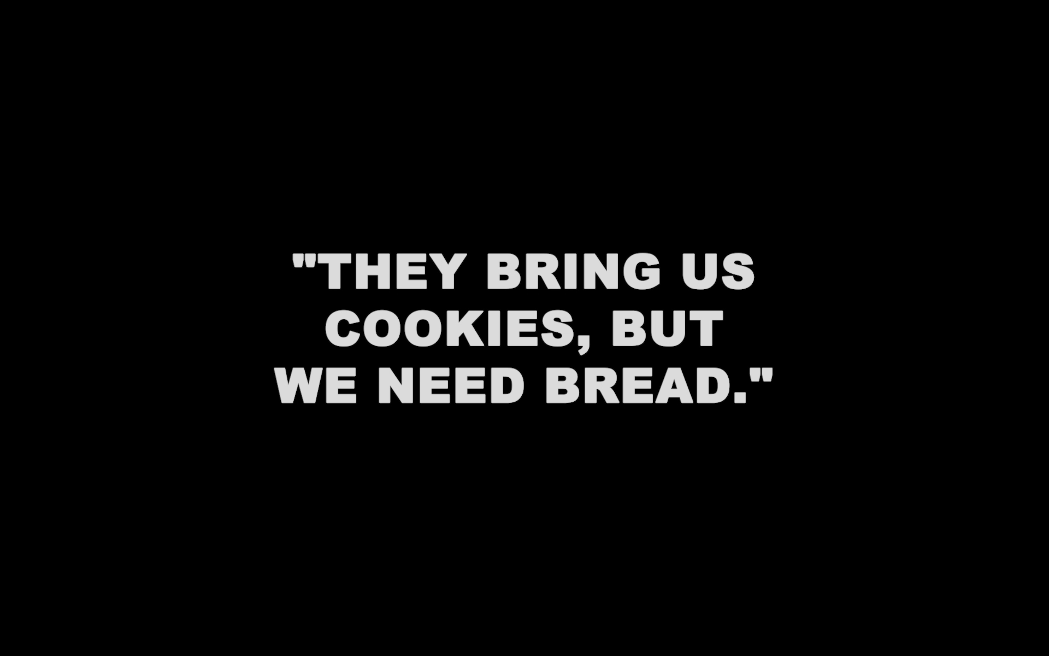 Still from the play: "They bring us cookies, but we need bread."