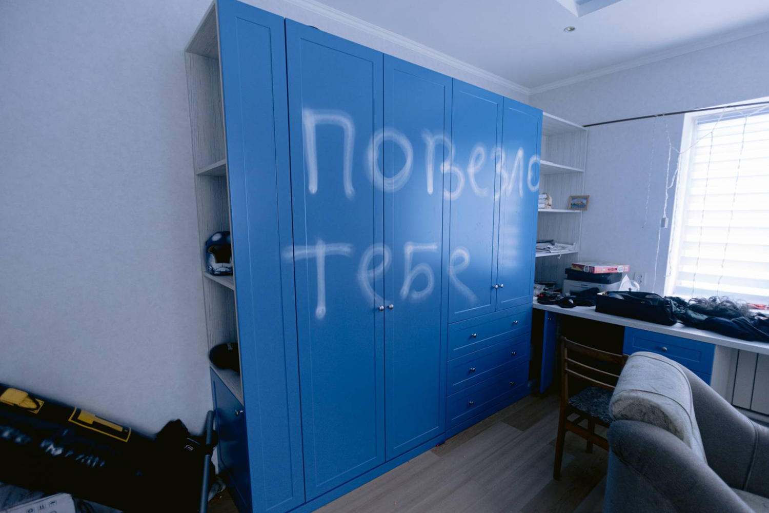 A blue wardrobe in a private apartment with inscription by Russian occupiers in Ukraine