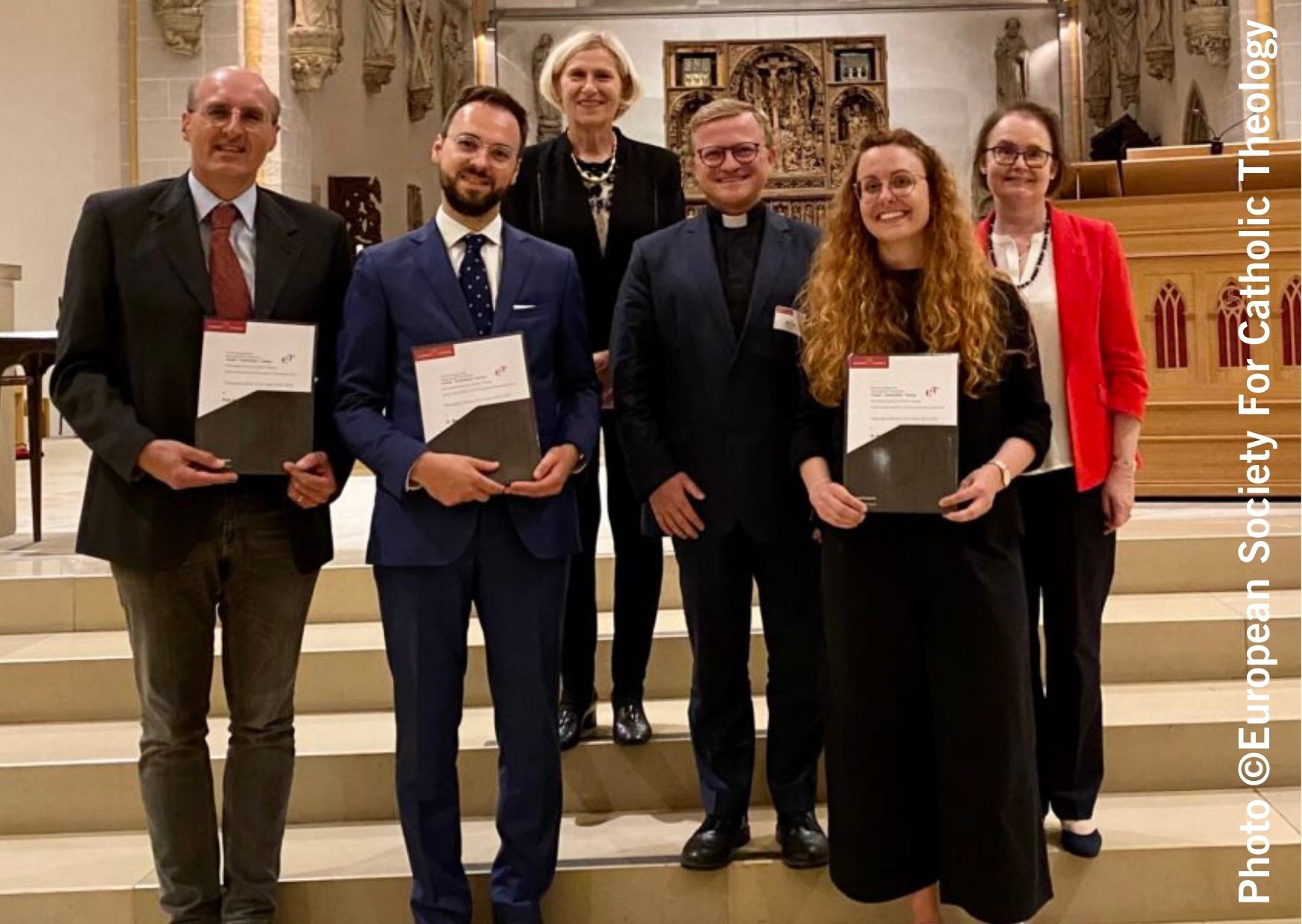 European Society for Catholic Theology book prizes award ceremony. the winners are standing the chancel steps 