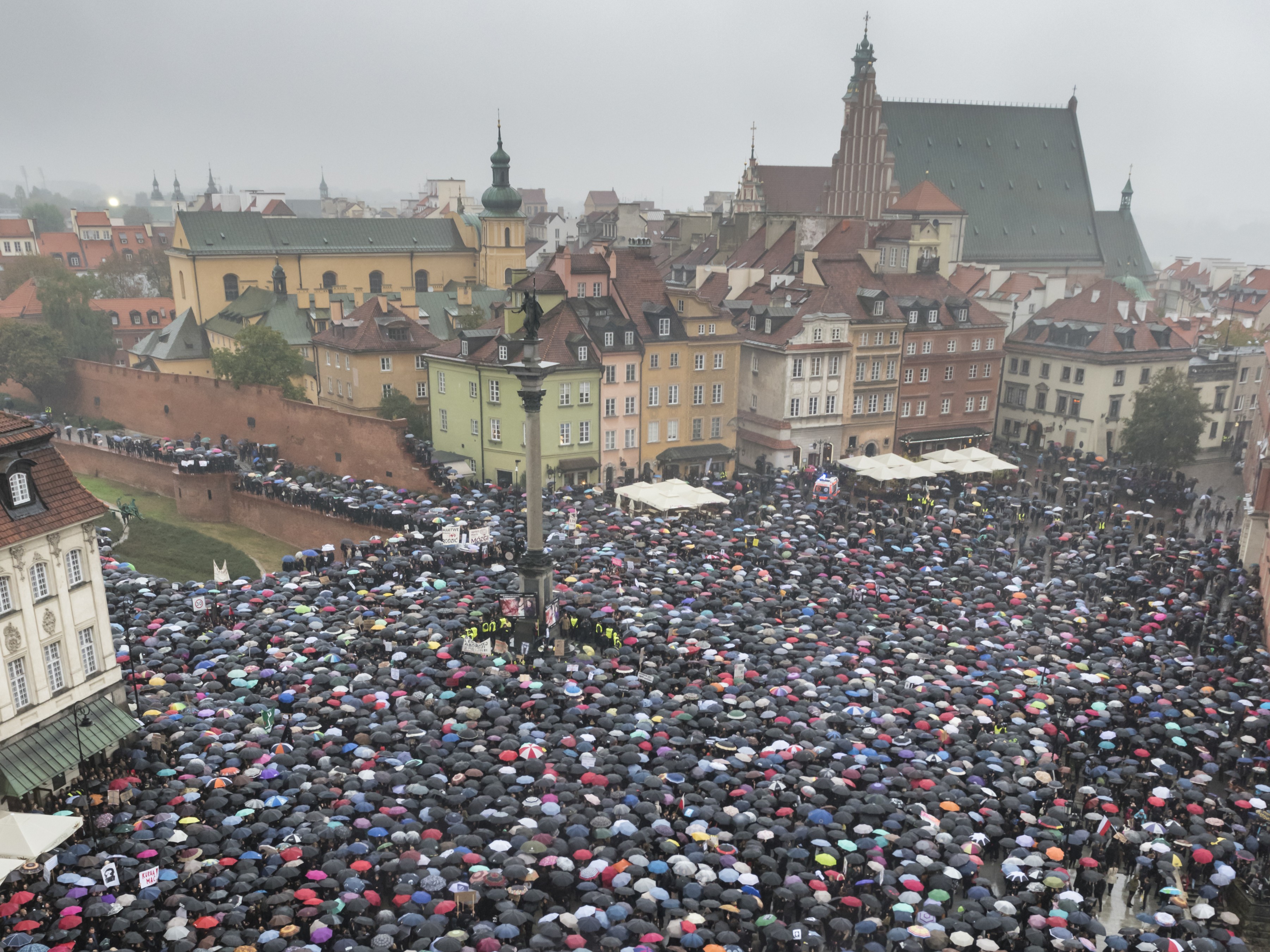 Polish women holding umbrellas protest a legislative proposal for a total ban on abortion
