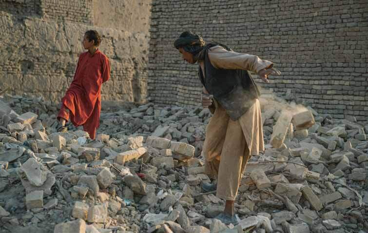 A man clears away the remains of a building in Alam Khail, a village in north Afghanistan, September 2021.