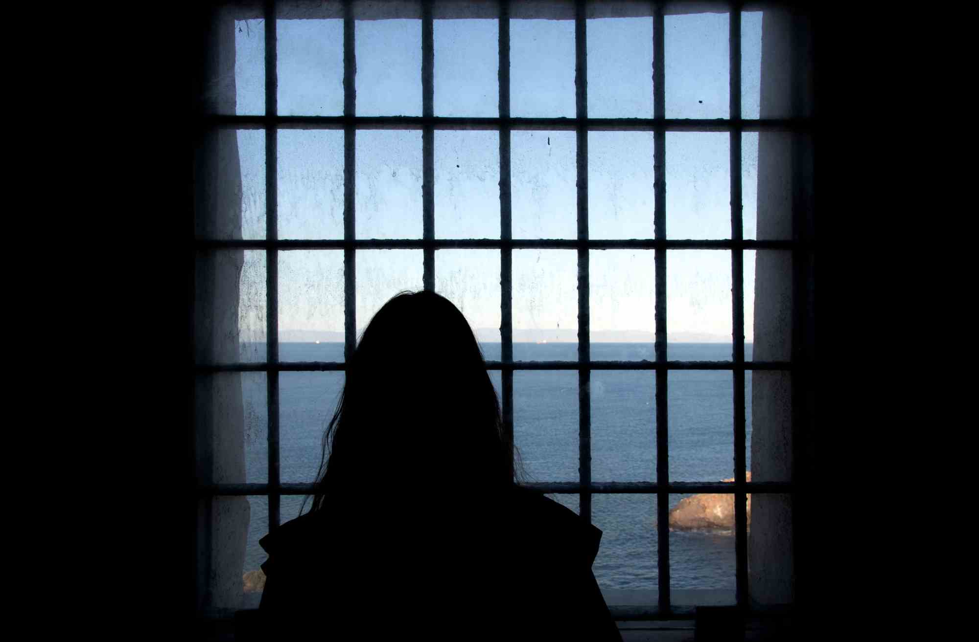 Photo of a woman looking out the window