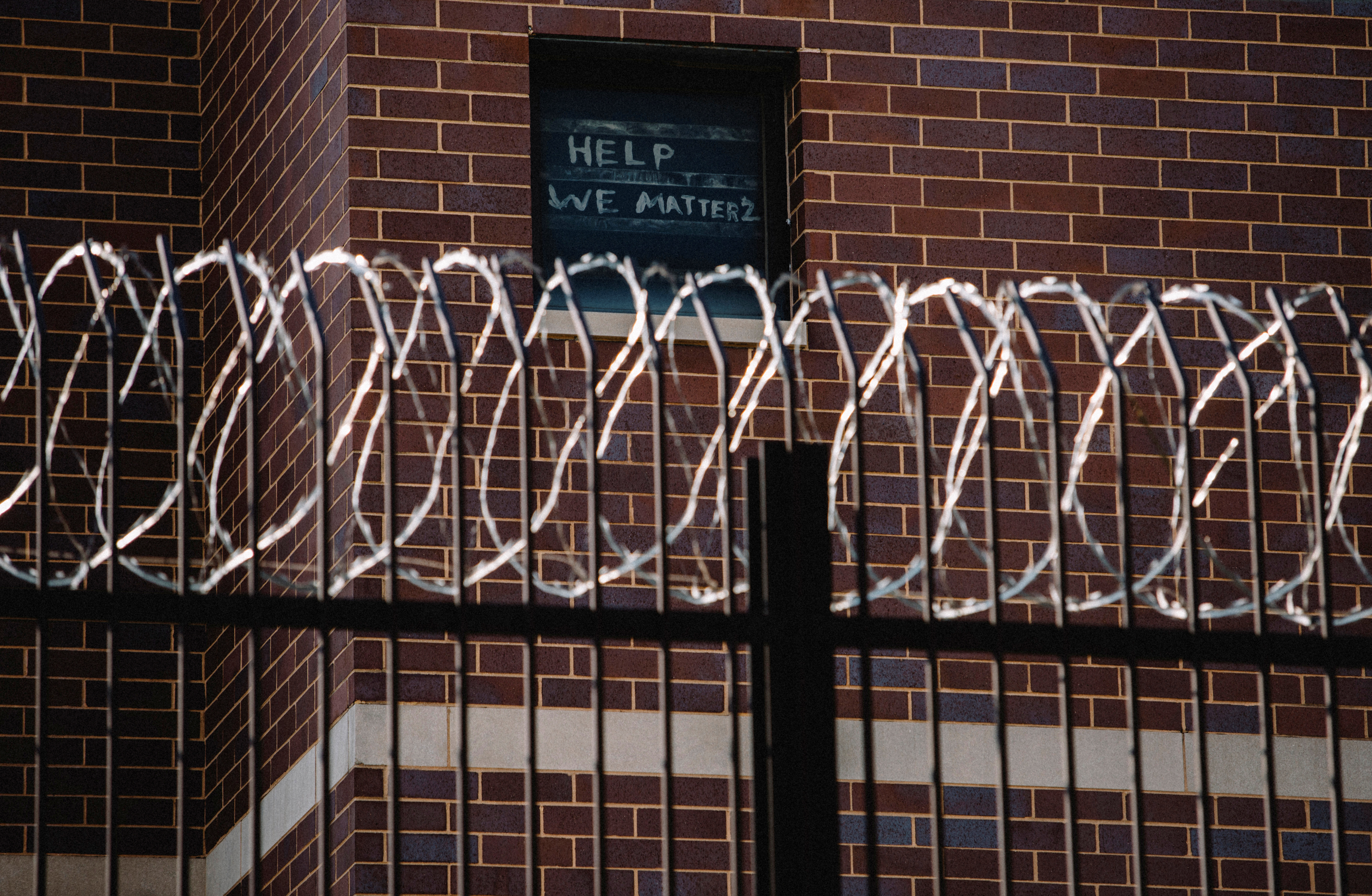 Signs made by prisoners pleading for help are seen on a window of Cook County Jail in Chicago, Illinois, U.S., April 7, 2020, amid the coronavirus disease outbreak.