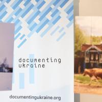 Roll up with Documenting Ukraine project logo and two pictures