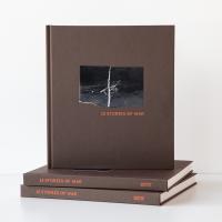 A pile of "13 Stories of War" books