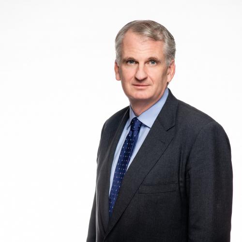 Portrait of Timothy Snyder, wearing a dark suit against a white background